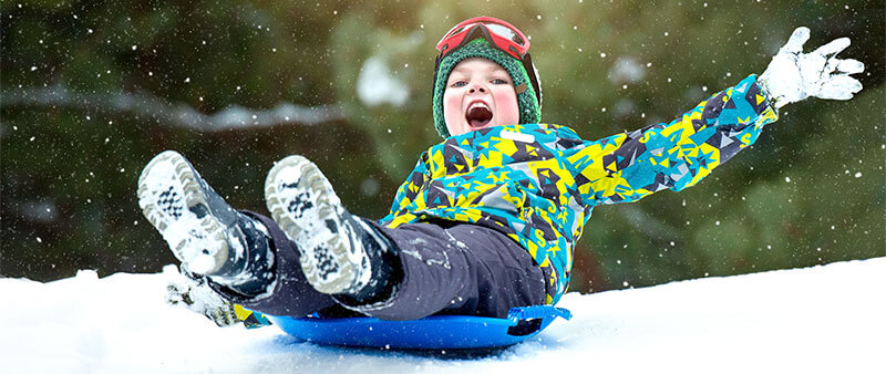 Happy kid sledding