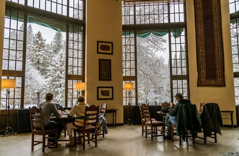 Enjoying snowy views from warm tables in The Ahwahnee