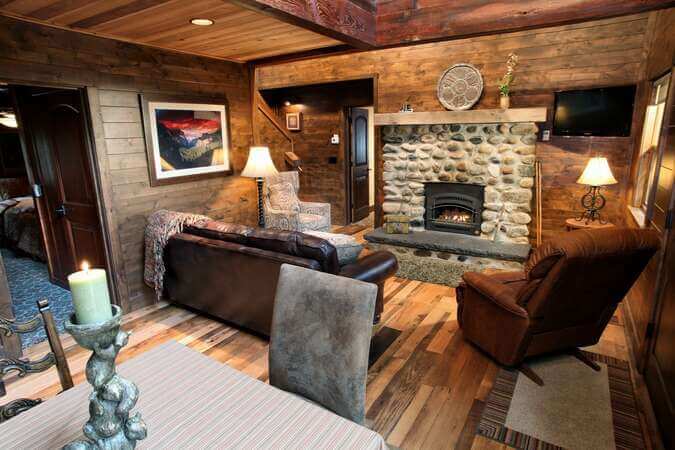 living room with stone fireplace and couches