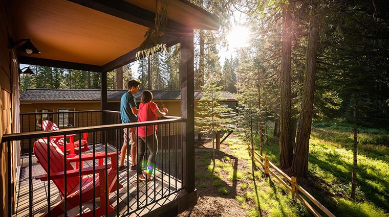 Couple on the deck of an Explorer Cabin at Tenaya at Yosemite