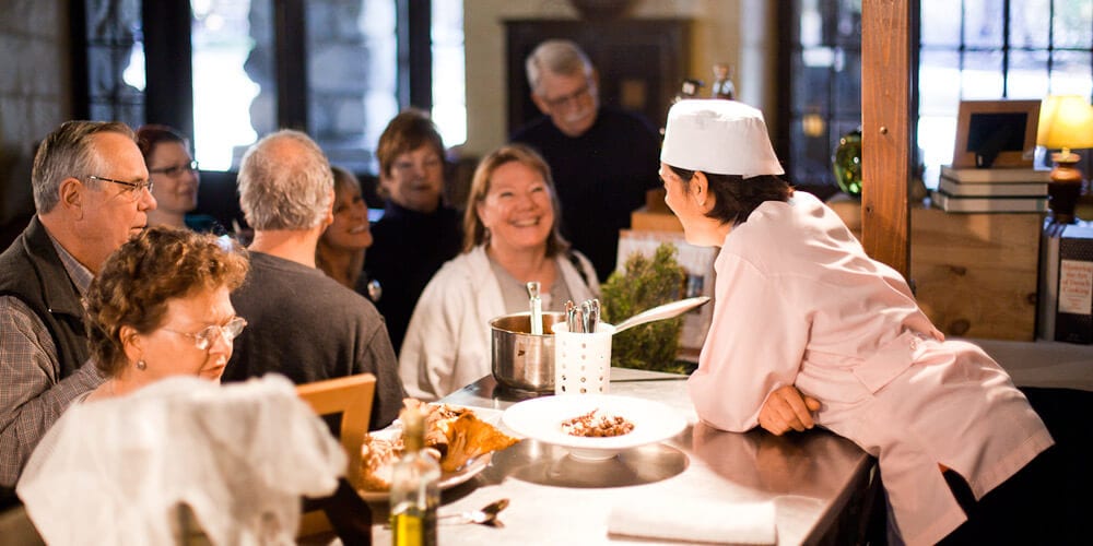 Chef talks with guests after a cooking demonstration