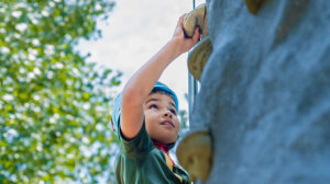 Child rock climbing on the climbing wall at Tenaya at Yosemite