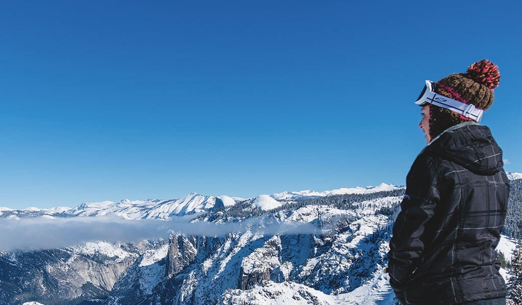 Woman enjoying the view from Dewey Point in the winter.