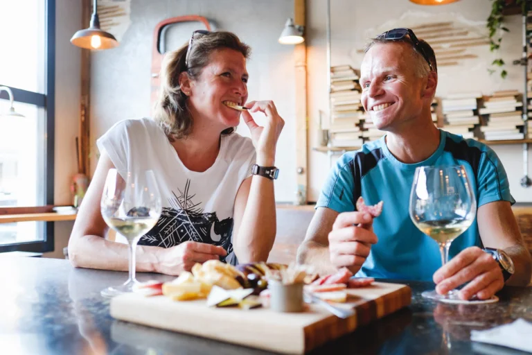 Dining restaurant couple enjoying wine and charcuterie