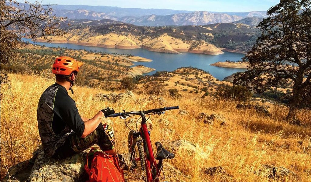 Mountain bike rider looking over Lake McClure