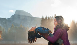 Mother and child in Cooks Meadow with Half Dome in the background