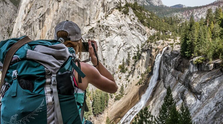 Hiker taking a picture of Nevada Fall on the Half Dome hike.