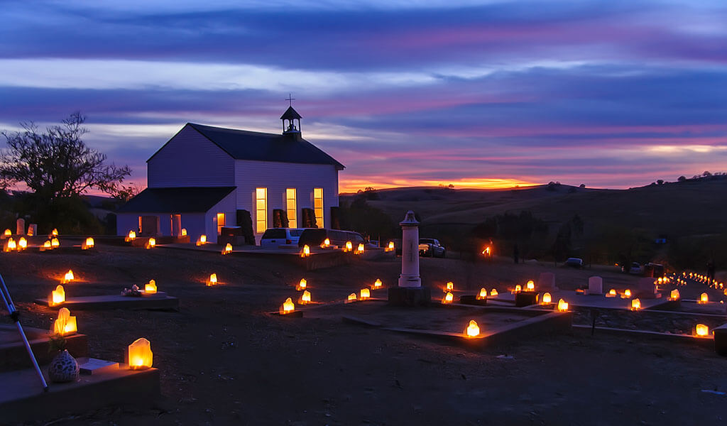lighted church and graveyard in Hornitos