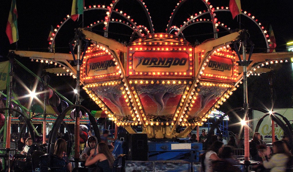 County fair ride - the Tornado - lit up at night