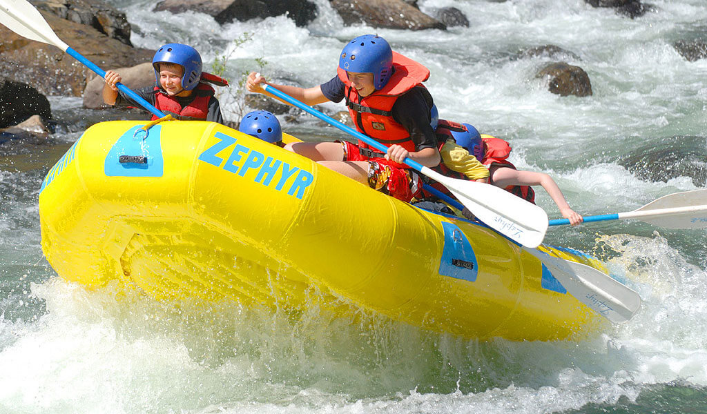 Kids whitewater rafting on the Merced Rive with a guide