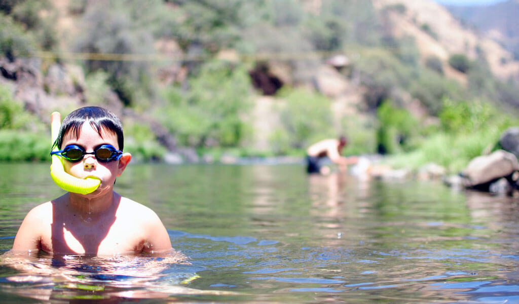 Boy swimming in the merced river