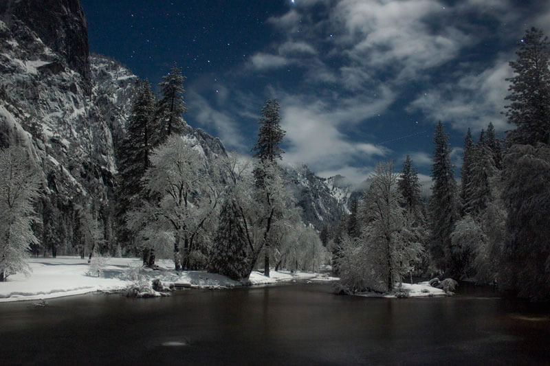 A star-filled snowy night overlooking the Merced River.