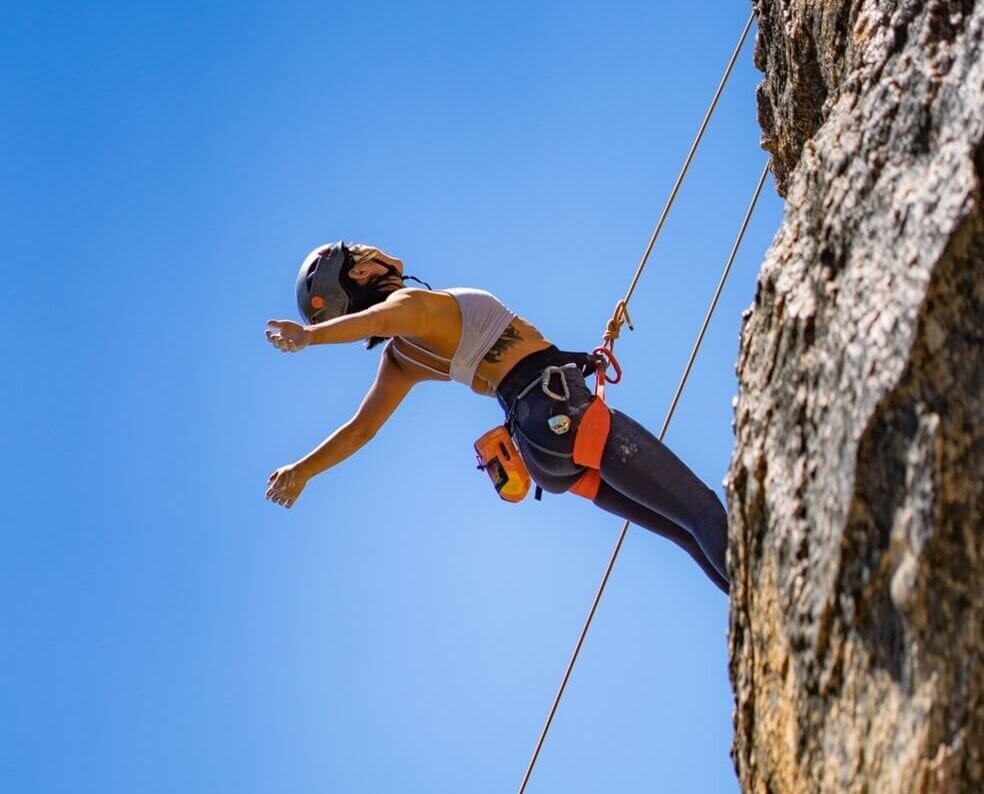 Climber hanging from rope