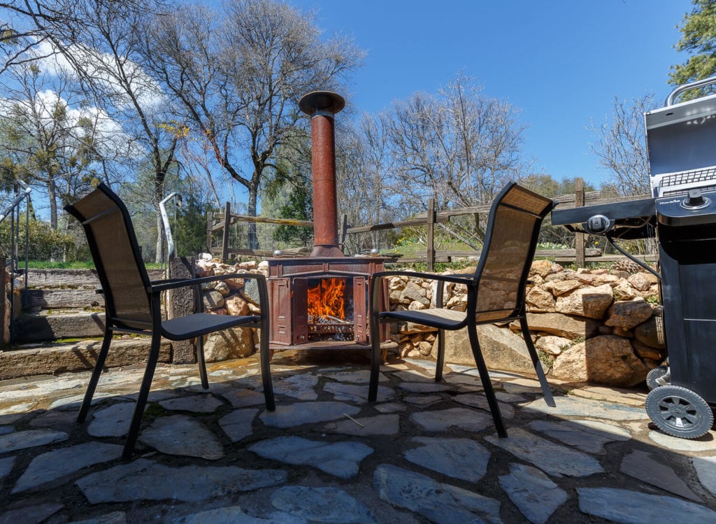 patio with outdoor fireplace and seating