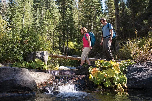 Hiking over a river in Yosemite