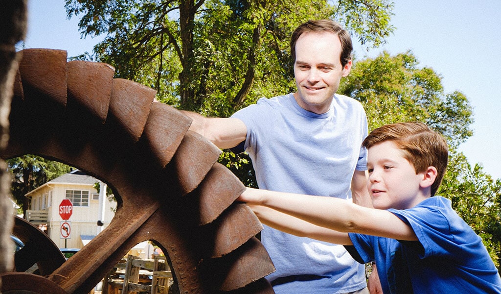 father and son exploring mining equpiment at the mariposa history center