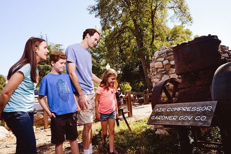 Family exploring mining equipment at the Mariposa History Center