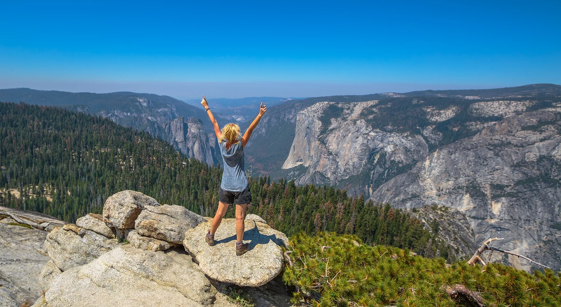 Woman cheering at scenic overlook