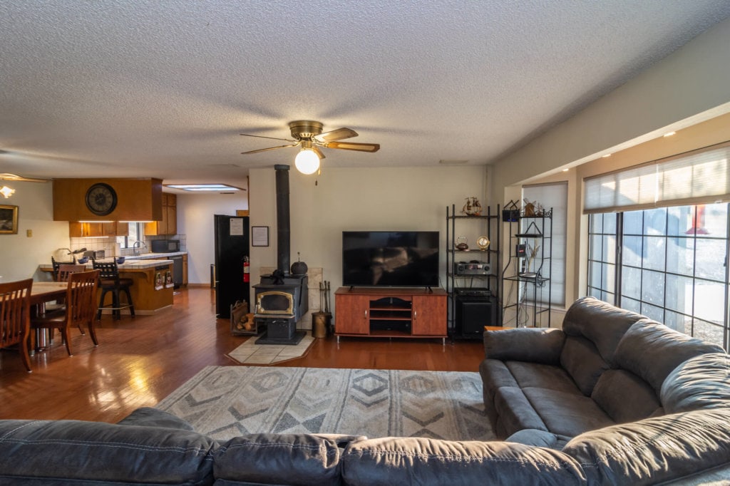 living room with television and wood stove