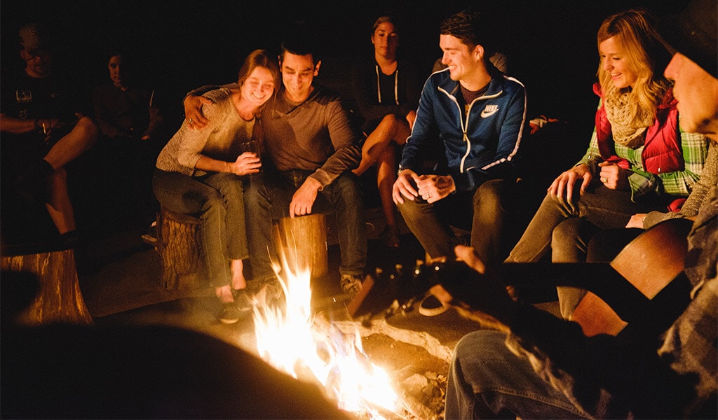 Group meeting around the campfire at The Yosemite Bug Rustic Mountain Resort.