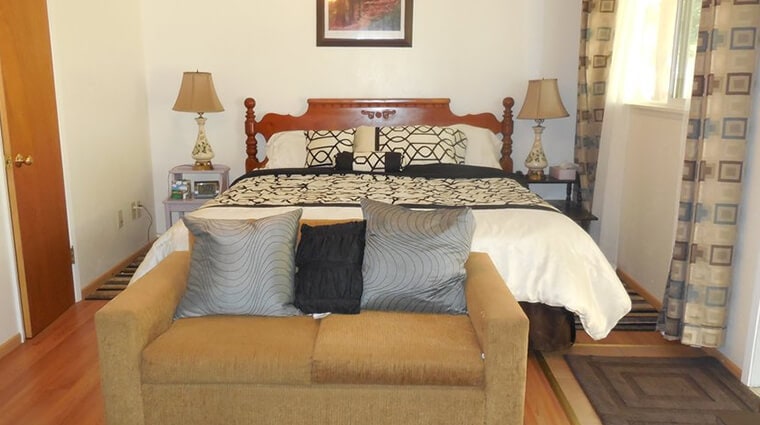 room with queen bed and sofa