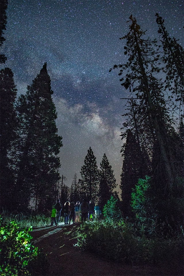 Group hiking with the Milky Way above.