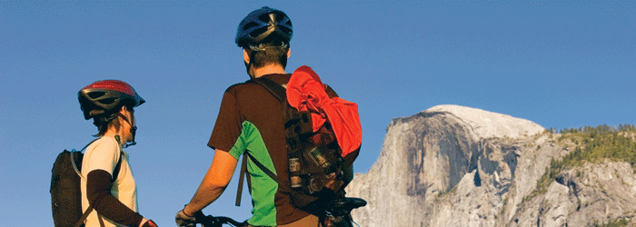 Two cyclists looking up at Half Dome