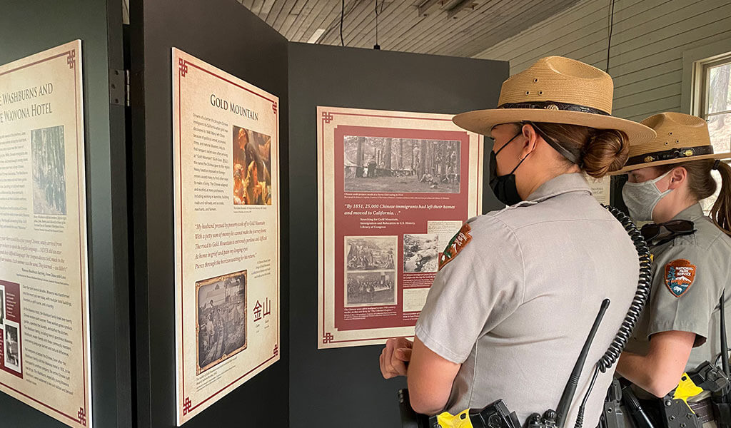 rangers look at chinese laundry exhibit at the yosemite history center