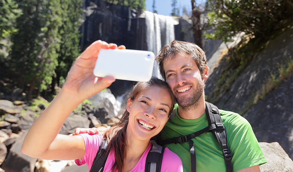 Couple taking a selfie with Vernal Fall in the background