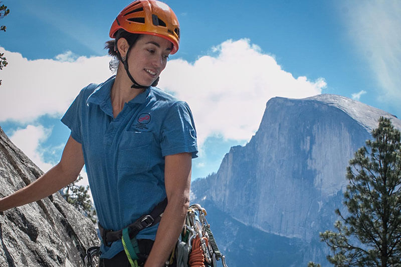 Yosemite Mountaineering School climbing guide, Miranda Oakley with Half Dome in the background.