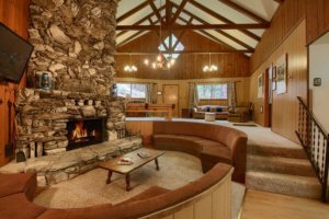 living room conversation pit with stone fireplace