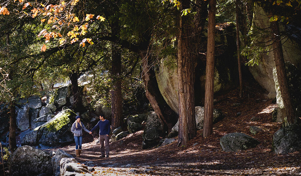 couple walking on a trail near mirror lake