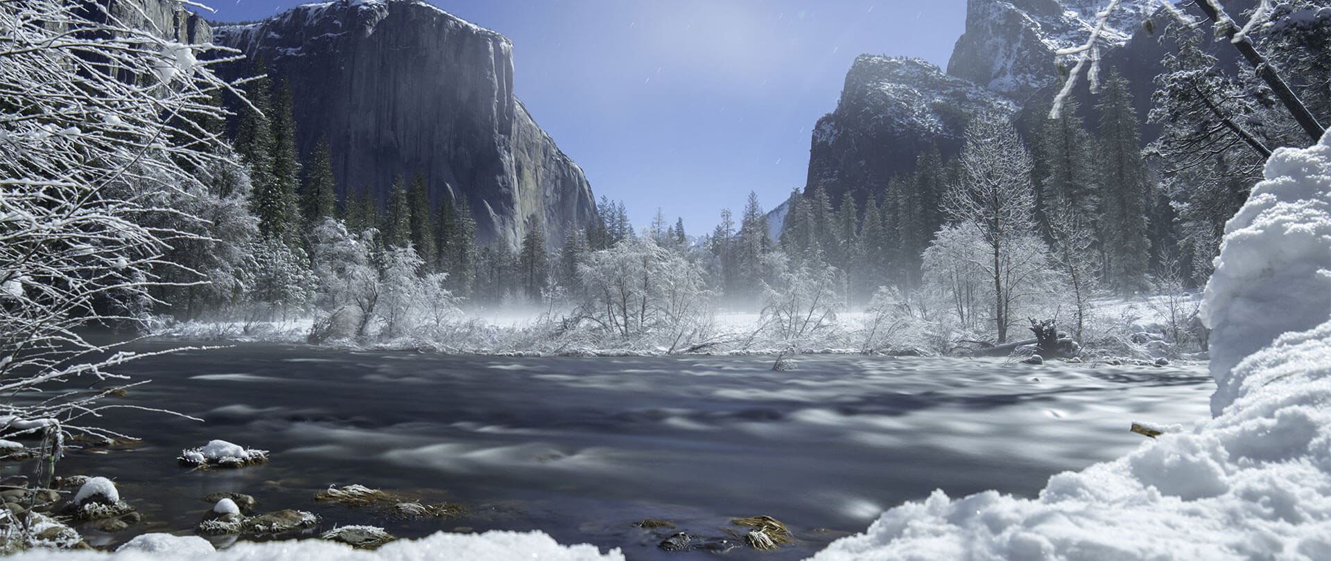 landscape image of yosemite valley covered in snow