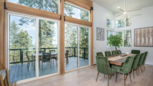 dining area with large windows and doors to deck