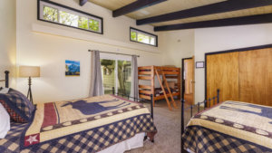 bedroom with beams and bunk beds