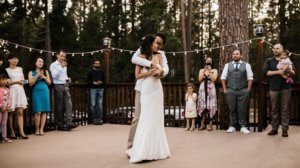 Wedding couple on the outdoor deck at The Redwoods In Yosemite Wedding and Event Center