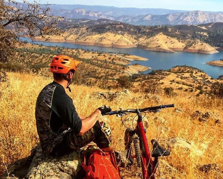 mountain biker pauses to enjoy the view at exchequer mountain bike park