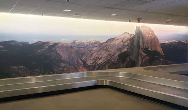 Baggage claim with Half Dome mural