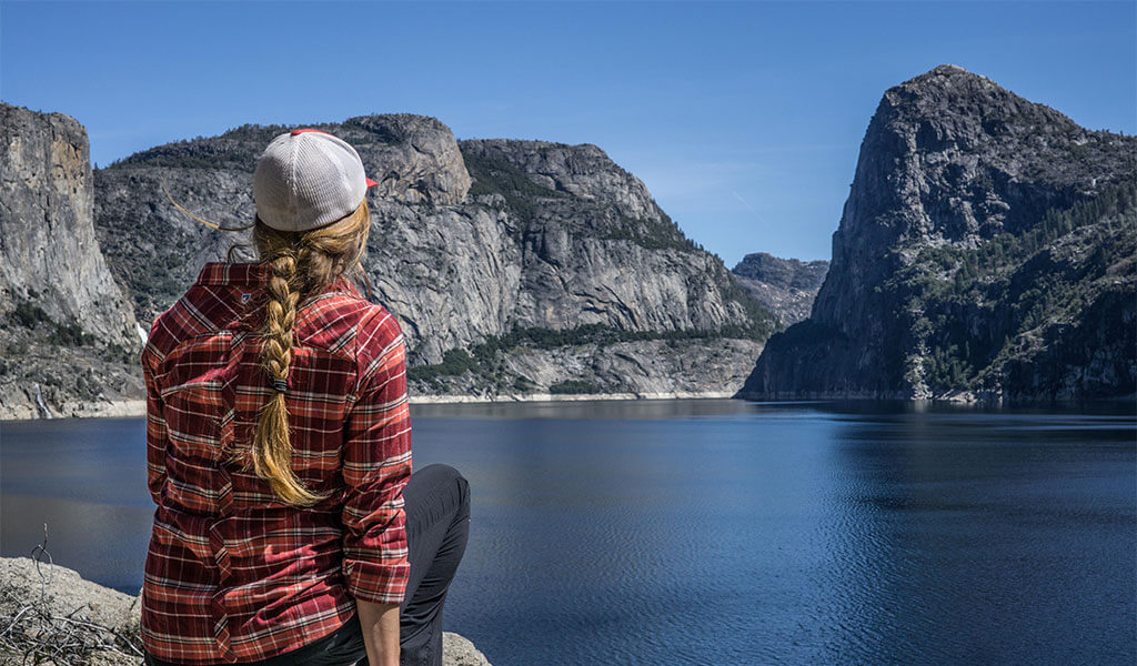 woman looking out at Hetch Hetchy reservoir