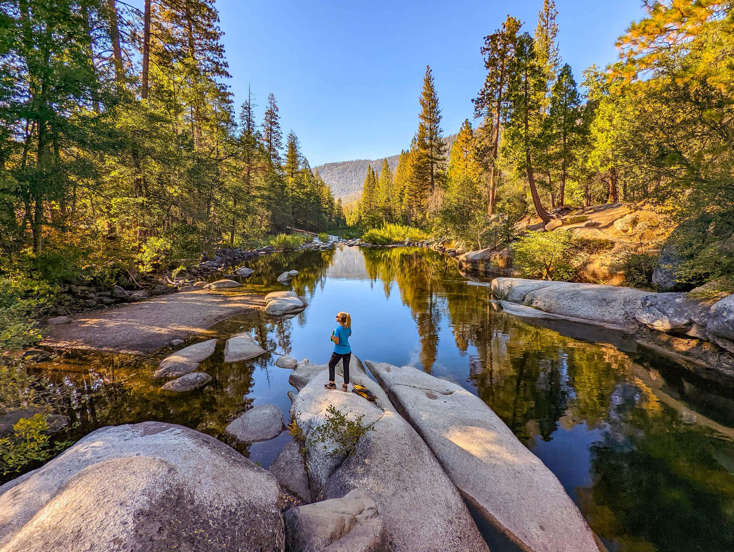 A woman admires the river in Wawona