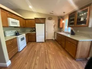 kitchen with wood floors and cabinets