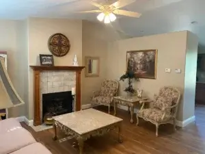 living room with ornate chairs and fireplace