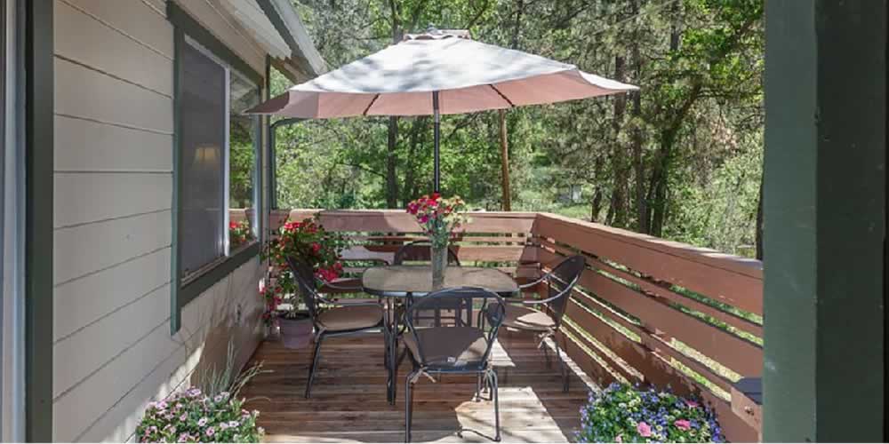 deck with table and umbrella