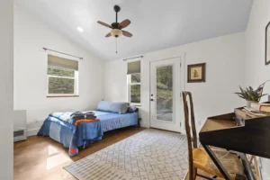 bedroom with queen bed and door to balcony