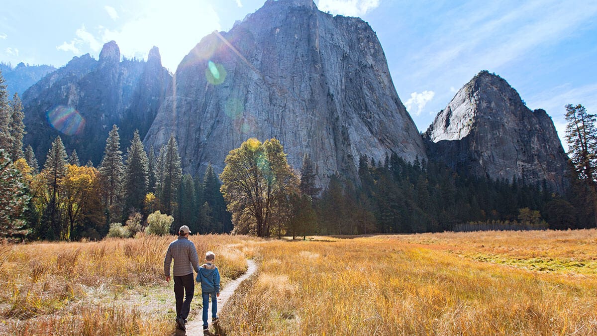 Father walking with his son with a view of Middle Cathedral