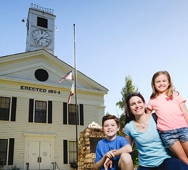 family posed in front of the historic Mariposa County courthouse