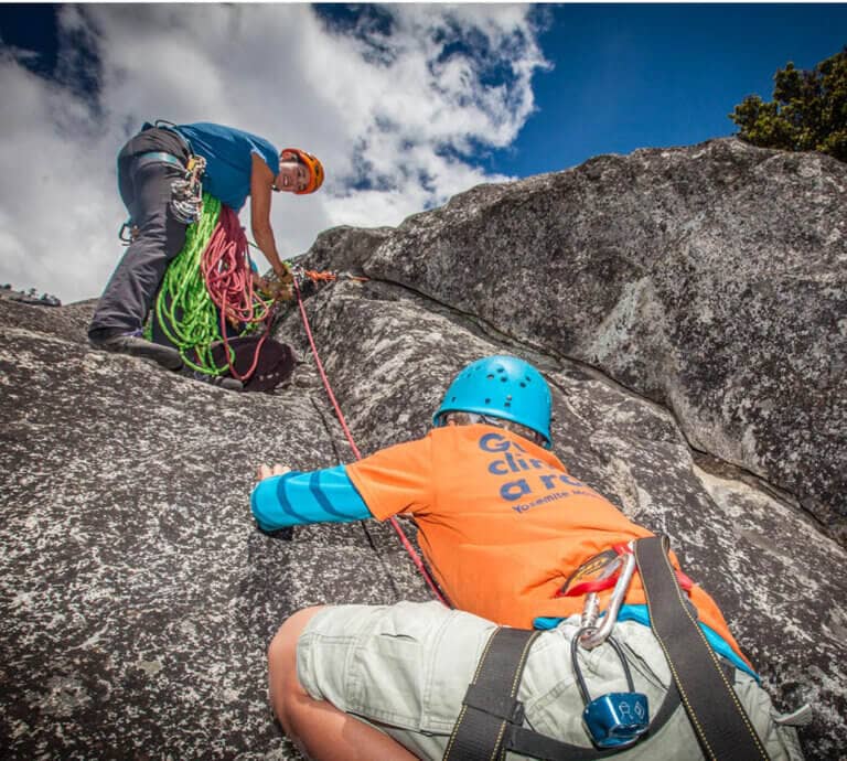 kid climbing with a Yosemite Mountaineering School climbing guide