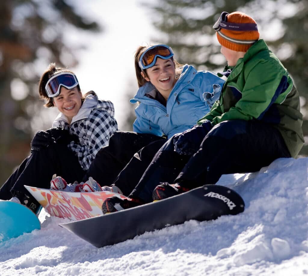 3 snowboarders chatting at Badger Pass in Yosemite