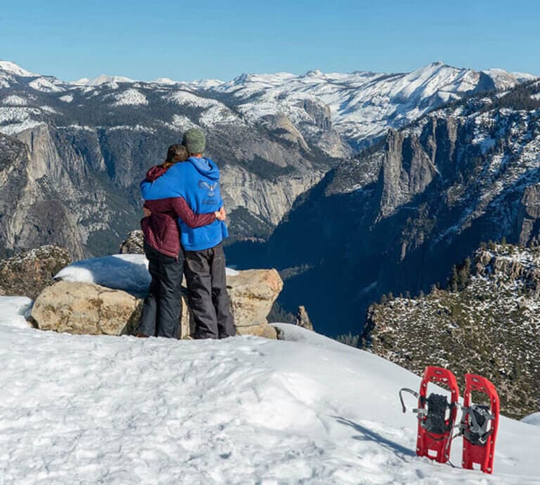 Couple at Dewey Point in winter looking over Yosemite Valley