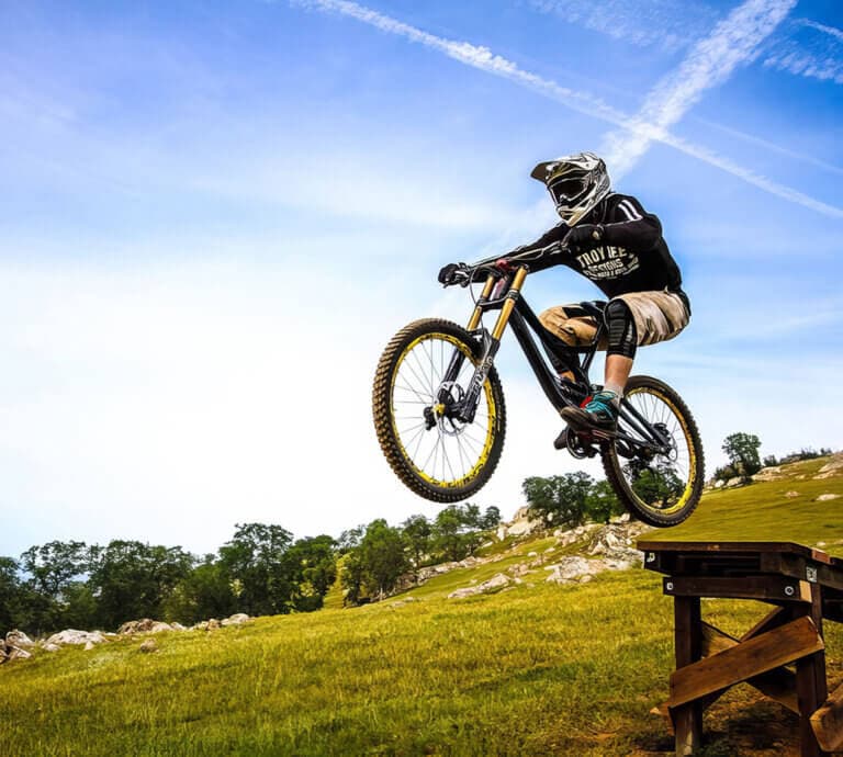 going off a jump at exchequer mountain bike park